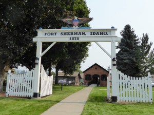 A 3/4 replica of the Fort Sherman entrance with the Powder House behind.